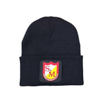 The S&M Dense Cuffed Beanie, made from hypoallergenic acrylic, features an emblem with "S&M American Bicycle Co" on a bold red and yellow shield. Designed for comfort, it is available in one size that fits most.