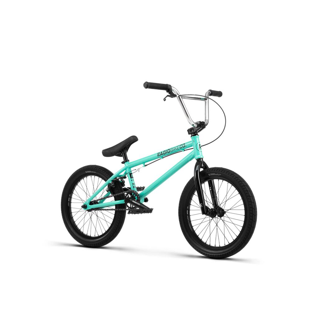 The Radio Saiko 18 Inch Bike, featuring a turquoise frame with black handlebars and seat, plus sleek Salt Tracer Tyres, stands out against a white background.