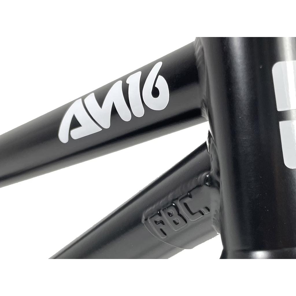 Close-up of the Fit Bike Co AM 16 Frame & Fork Kit with black frame/fork, featuring white "Fit AM 16" text and engraved "FBC" marking, ideal for young shredders.