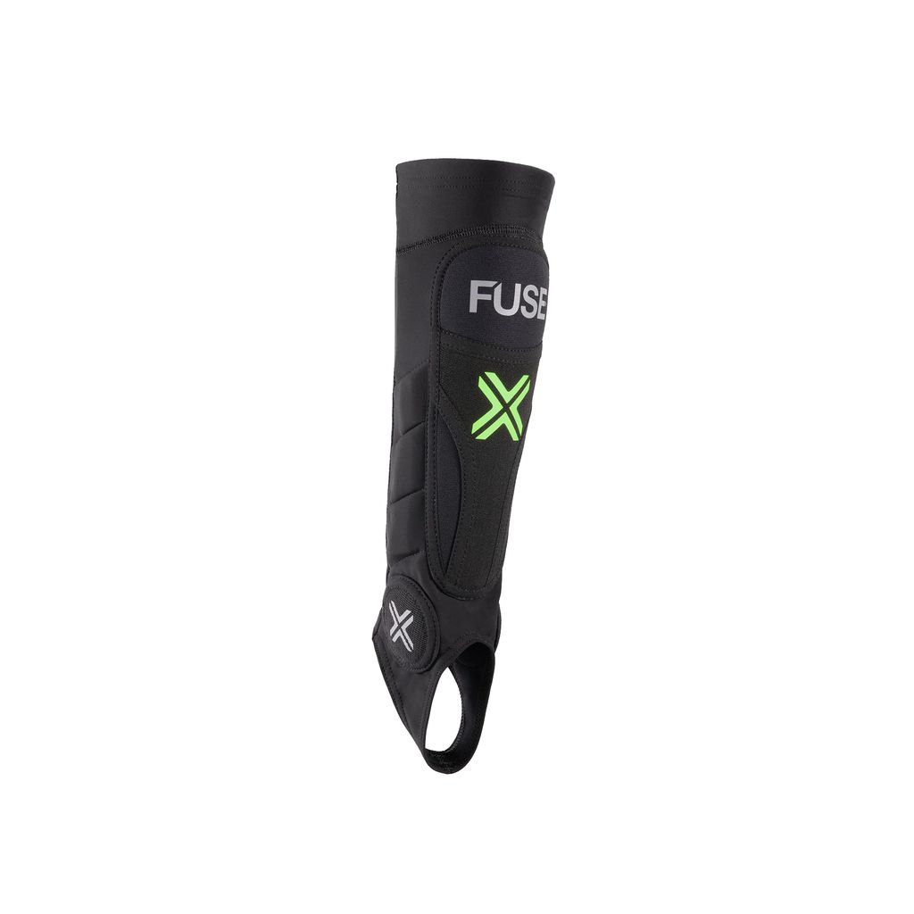 The Fuse Omega Pro Shin/Ankle Combo Pads (Pair) showcase a sophisticated black shin guard with a green "X" design, reflecting its contemporary style. Equipped with advanced SAS-TEC inserts and an innovative strapless design, these pads provide comfort and protection without sacrificing performance.