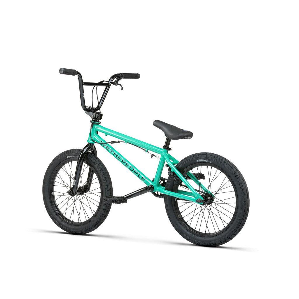 Viewed from the side against a white background, the Wethepeople CRS FS 18 Inch BMX Bike displays its teal frame with contrasting black handlebars, seat, and tires for an elegant freestyle appearance.