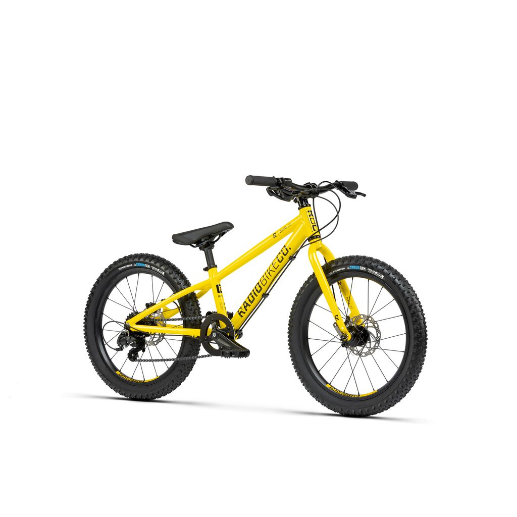 Introducing the Radio 20 Inch Zuma Bike: a yellow children's mountain bike featuring large tires, a lightweight alloy frame, and disc brakes. The brand name is prominently visible on the frame.