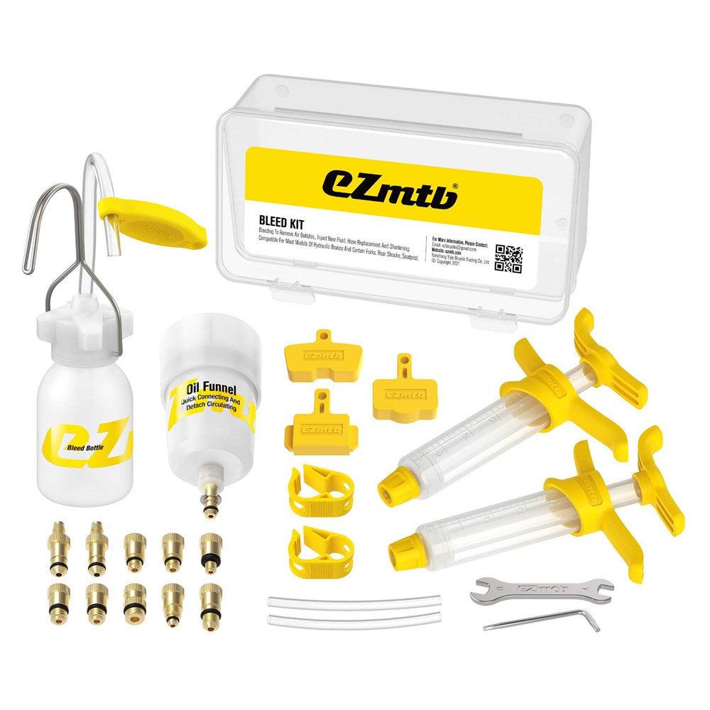 A bike brake bleed kit consisting of syringes, various brass fittings, a bleed funnel, oil pot, plastic wrenches, and a storage case with the "EZ MTB Universal Bleed Kit - Standard Kit" logo.