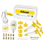 A bike brake bleed kit consisting of syringes, various brass fittings, a bleed funnel, oil pot, plastic wrenches, and a storage case with the "EZ MTB Universal Bleed Kit - Standard Kit" logo.