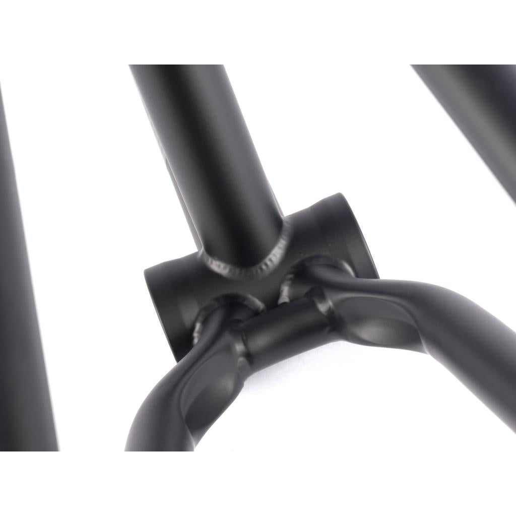 Close-up of a black metal bike frame's joints, highlighting clean welds and a matte finish. The 2022 BSD Soulja V4 Frame features precision with invest cast dropouts, enhancing its sleek design.