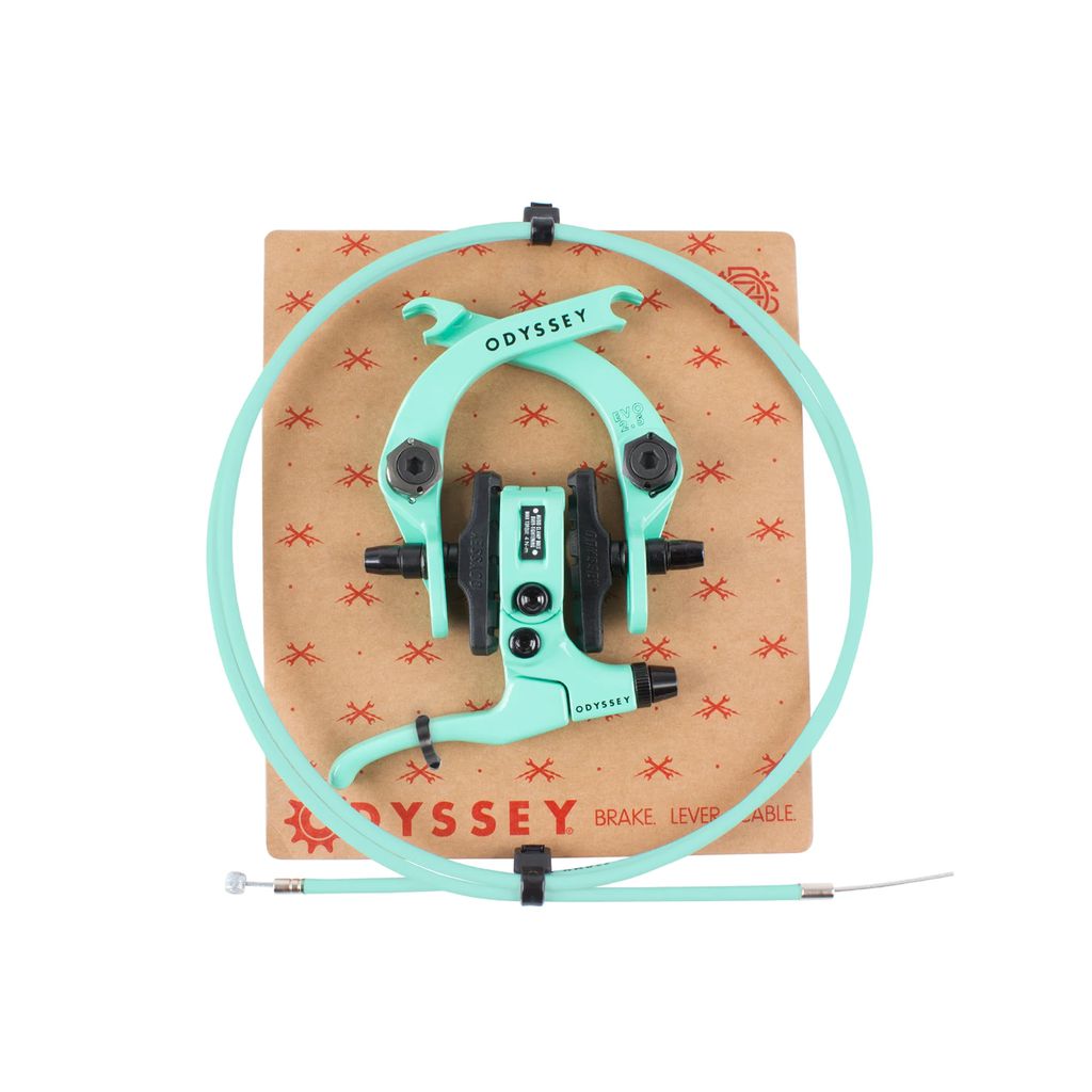 The Odyssey Evo 2.5 Brake Kit, in turquoise, includes a brake with lever, cable, and calipers on a brown board. It features modular hardware and aluminum forged components for durable and precise rides.