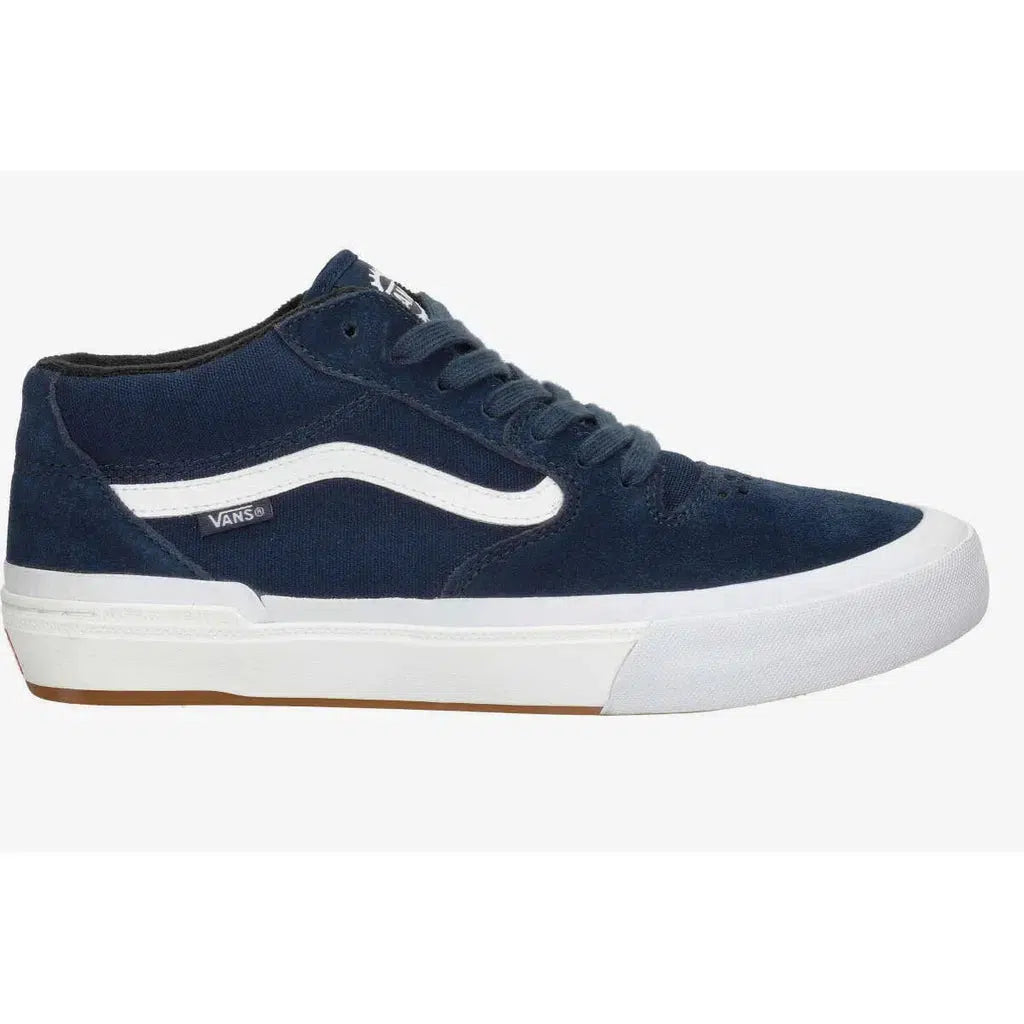 The Vans BMX Style 114 - Navy/White is a mid-top, blue sneaker with a white stripe, waffle cup sole, gum outsole, and a signature Vans logo on the side. It features a mid-cut design with classic laces.