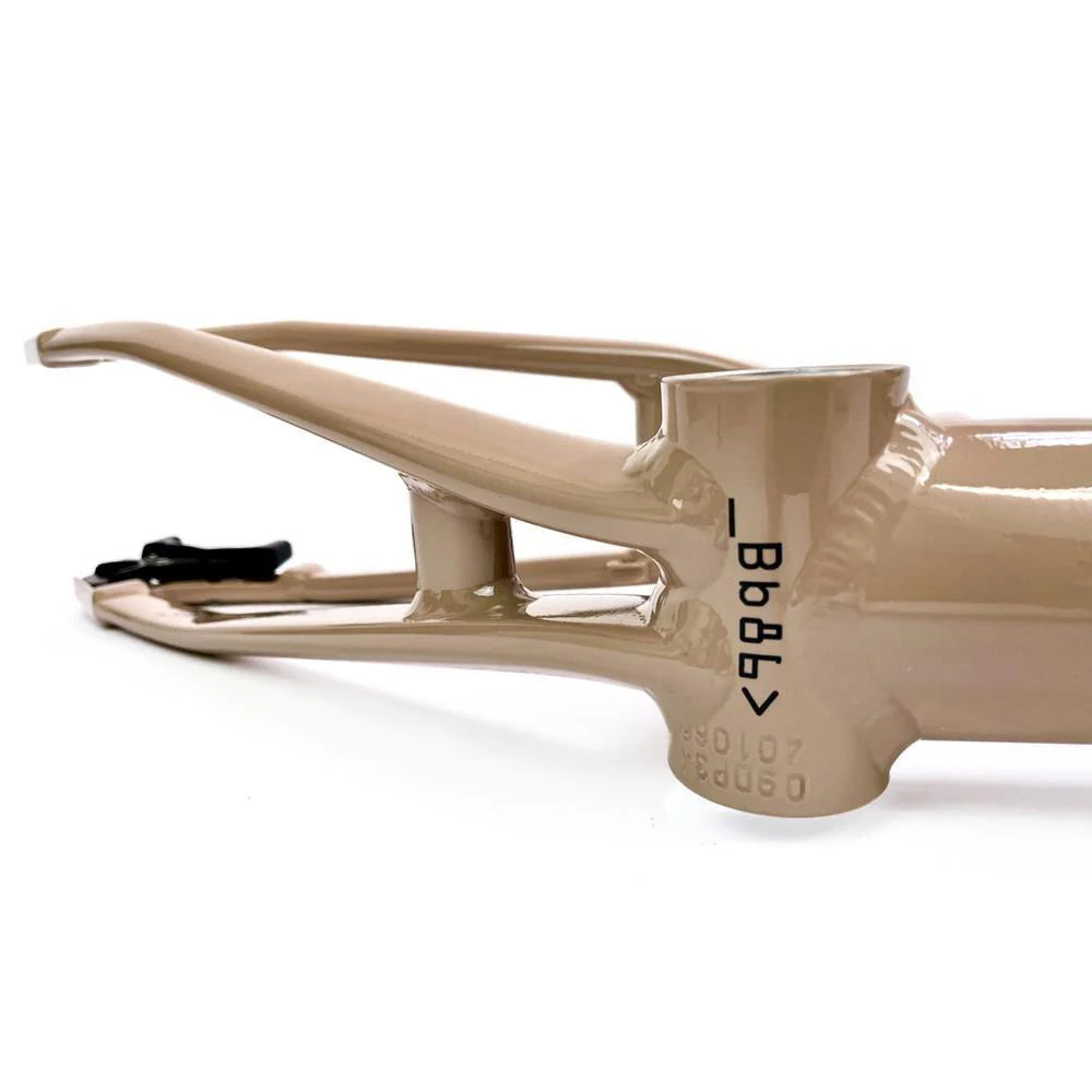 Close-up of a beige Staystrong V5 Disc Pro L Frame section with visible welding, showing part of the seat stay, chain stay, and bottom bracket area with serial number. The 6061 alloy tubing provides durability and strength.