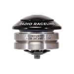 Close-up of a bicycle headset with "RADIO RACELINE" text on the top black cap. The silver body showcases inscriptions including "TH INDUSTRIES 1" ACB 36°x45° 373#". This Radio Raceline 1-Inch Integrated Headset features lightweight CNC machined components and high-precision bearings for optimal performance.