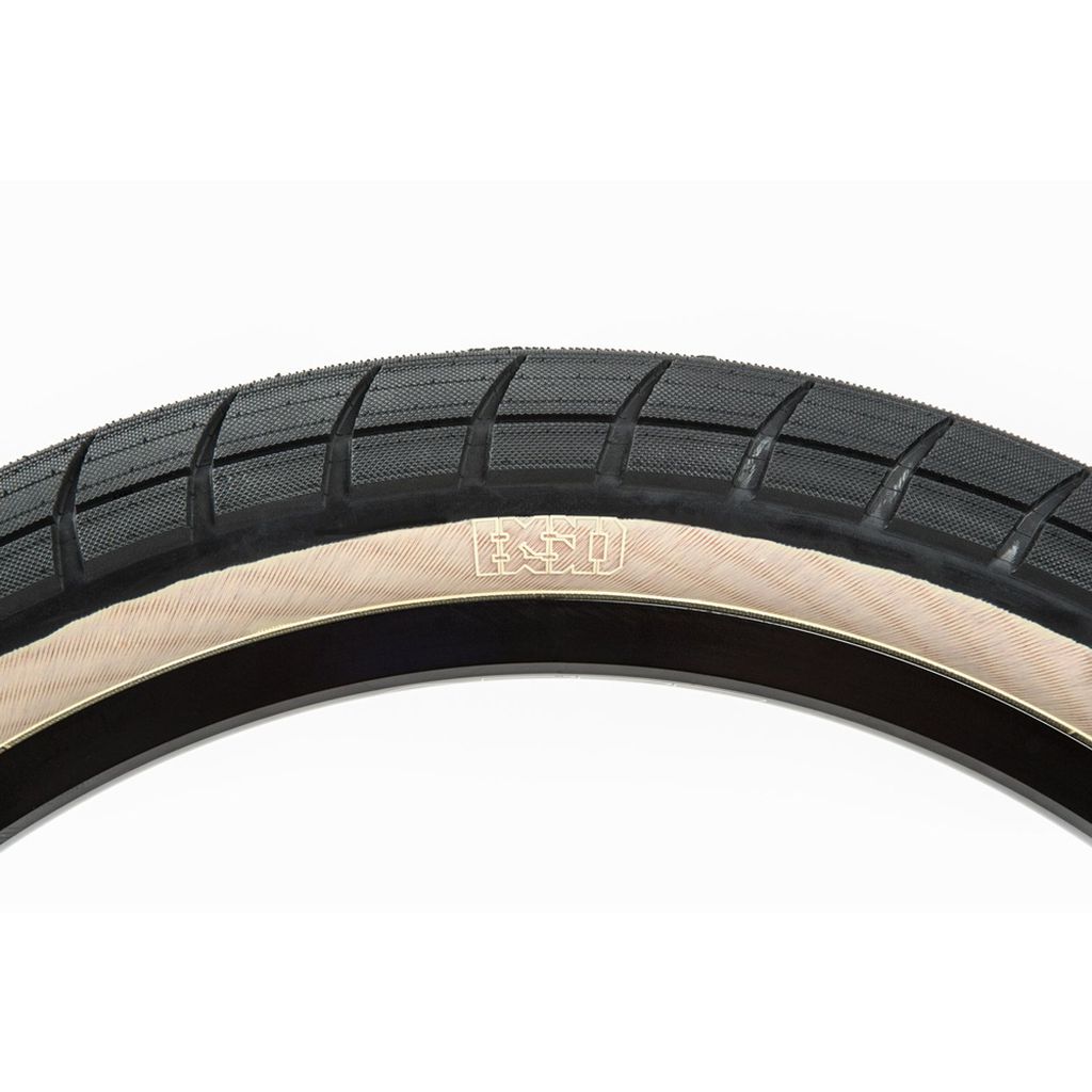 Close-up of a BSD Donnasqueak Tyre showing micro-knurled tread for low rolling resistance and "BSD" in stylized letters on the sidewall.