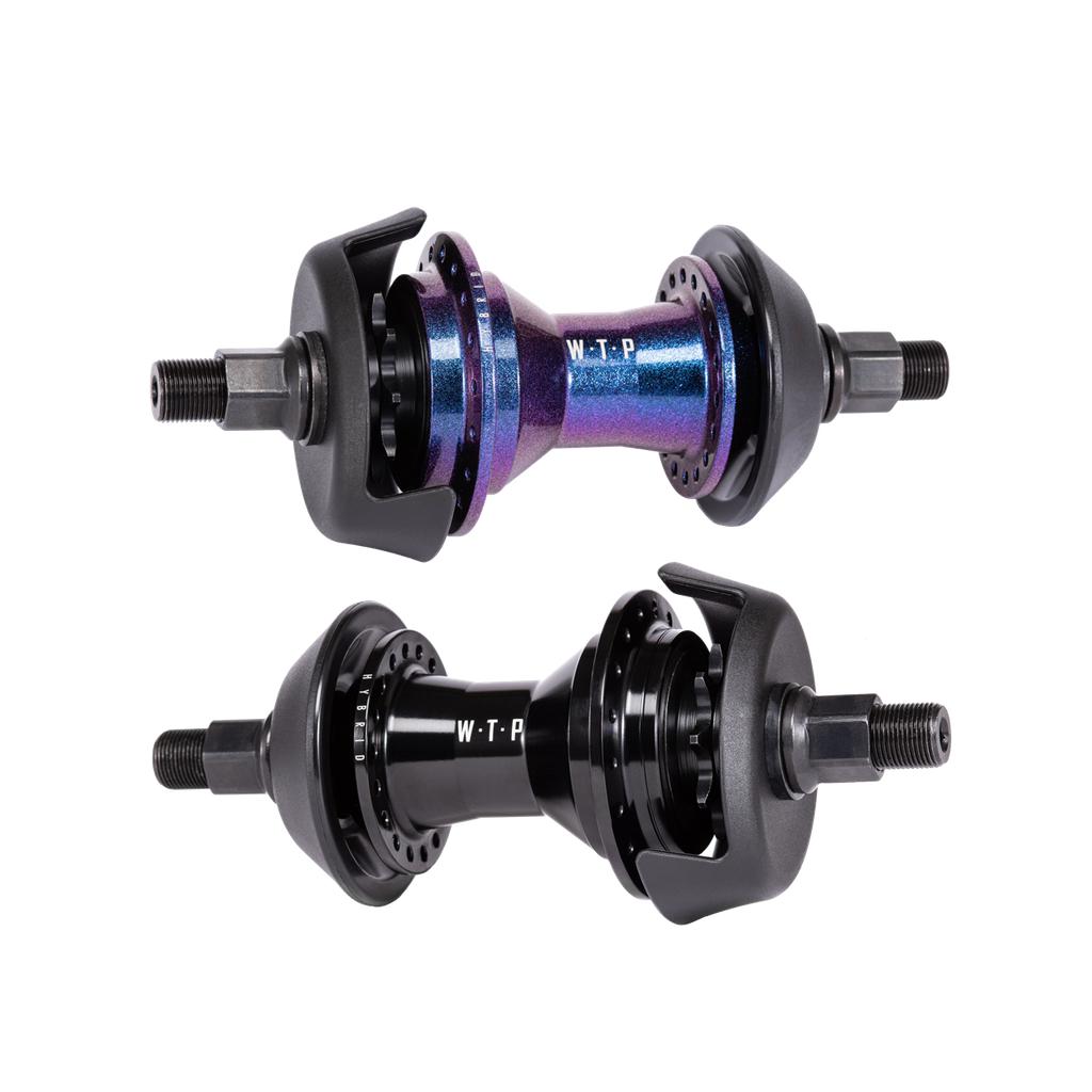 The Wethepeople Hybrid Hub, available in iridescent purple and black with the "WTP" logo, is elegantly displayed on a white background. Designed for BMX bikes, it features hub guards and axle bolts, making it ideal for versatile riding styles.