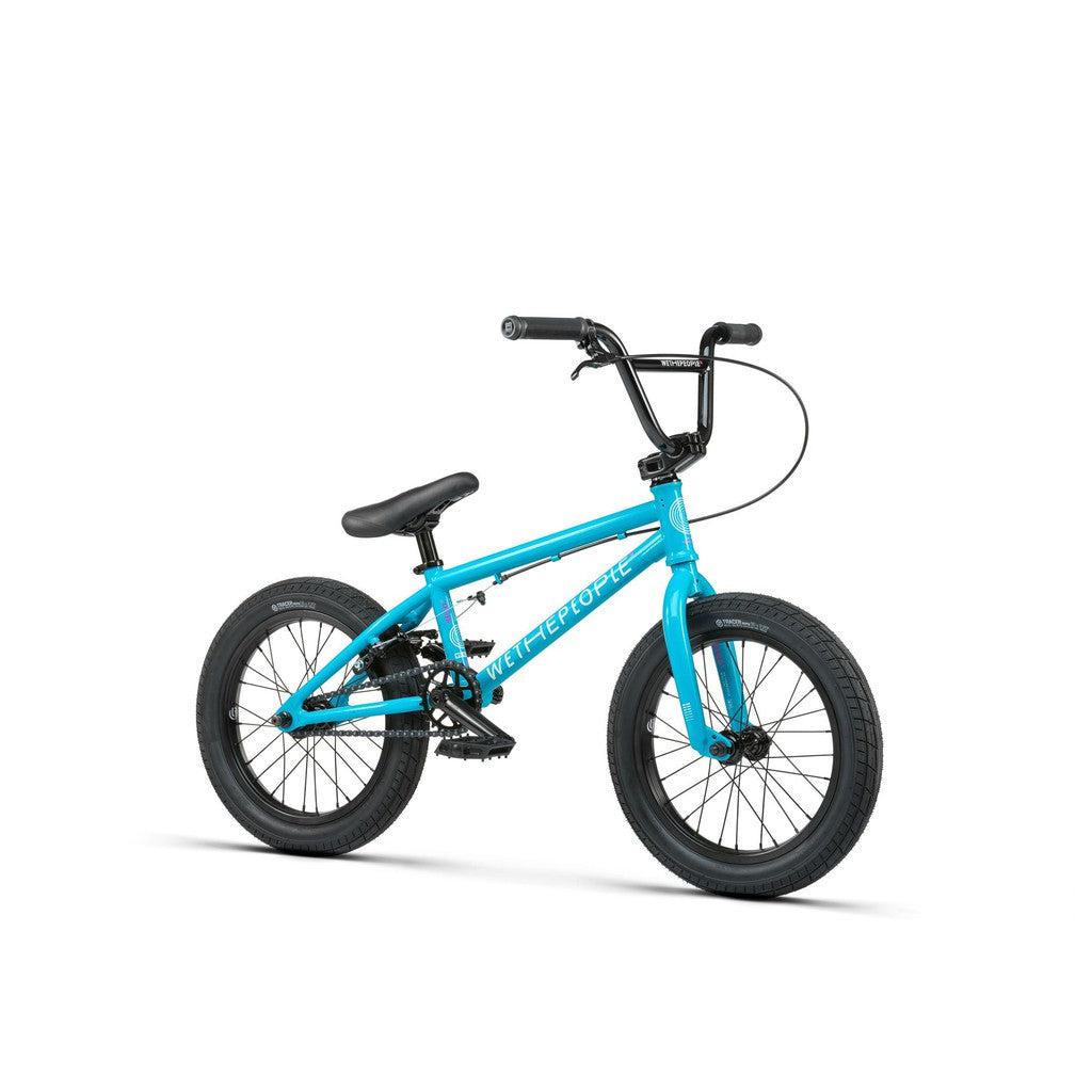 The Wethepeople Seed 16 Inch Bike, a turquoise BMX shredder with black handlebars and saddle, features Salt Rookie Cranks for top performance. Ideal for freestyle riding, it stands against a plain white background, capturing the bike's adventurous spirit.