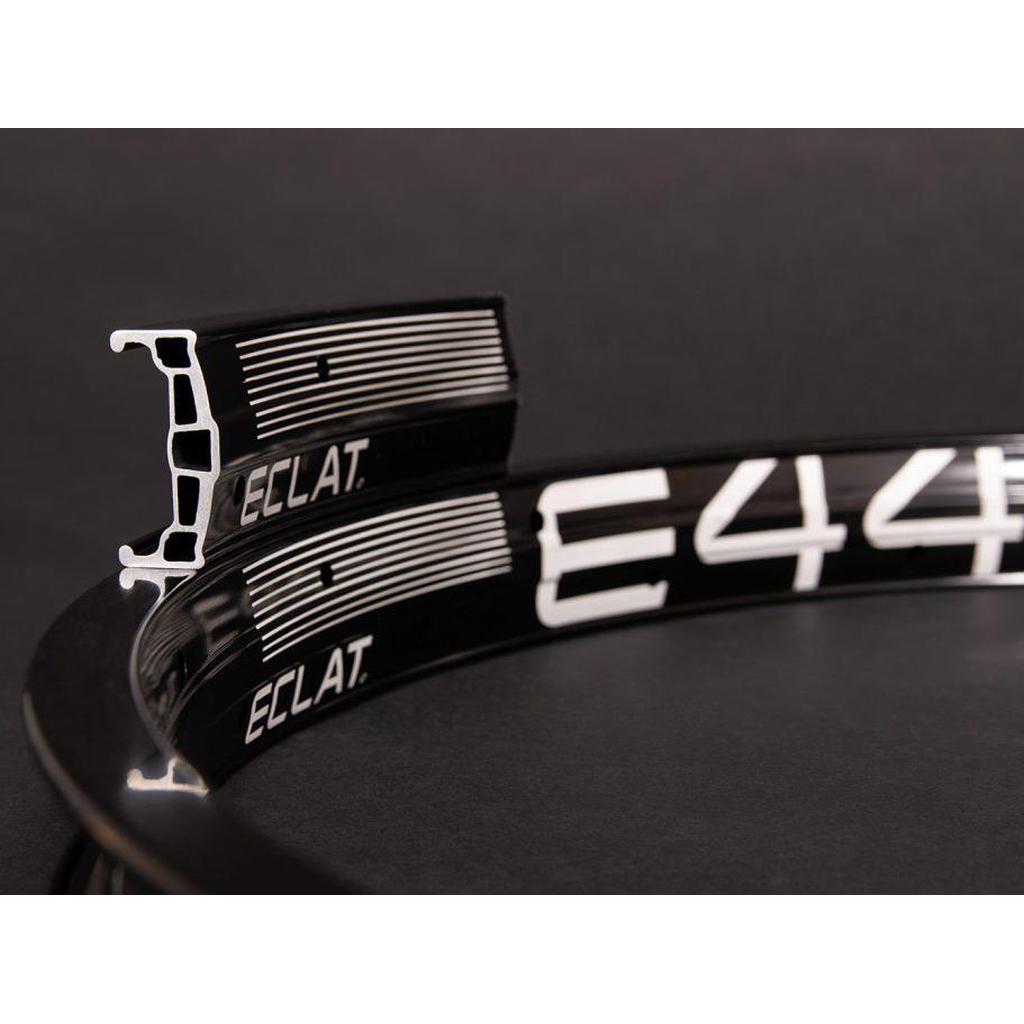 A black and white bicycle rim marked "ECLAT" and "E44," against a dark background. The lightweight Eclat E440 Rim (36H) is engineered for BMX riders seeking a strong wheelset.