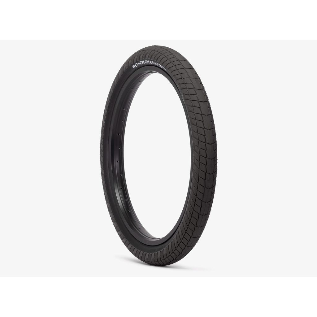 A single Wethepeople Overbite Tyre (20x2.35, Black) with a durable sticky compound and micro knurled tread pattern is shown against a plain white background. This all-rounder tyre is upright, displaying the sidewall and tread.