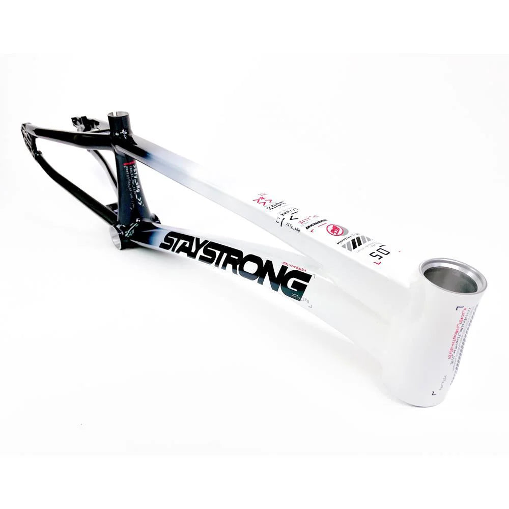 A BMX bike featuring an aluminium race frame with a gradient color transition from black at the rear to white at the front. The text "Staystrong V5 Disc Pro XXXL Frame" is prominently printed on the down tube, adding a bold statement to its sleek design.