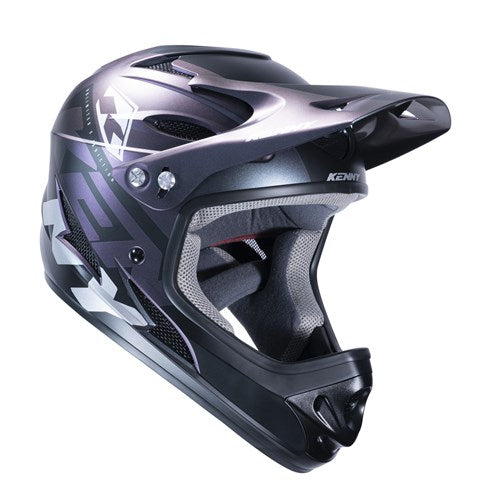 The Kenny Racing Downhill Helmet / Prisme is a black and silver full-face helmet with a visor, graphic design, and brand logo. It's made with an injected plastic shell and meets Australian Certified standards for safety and quality.