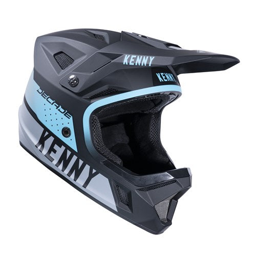 The Kenny Racing Decade Full Face Helmet in black and turquoise, displays the brand name in white text on the side and front. Equipped with MIPS technology, it's ideal for downhill biking enthusiasts seeking safety and style.