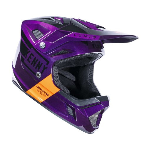 The Kenny Racing Decade Full Face Helmet in Candy Purple and black features orange accents, branded text, a visor, and chin guard. It includes an adjustable padded chin strap for comfort.