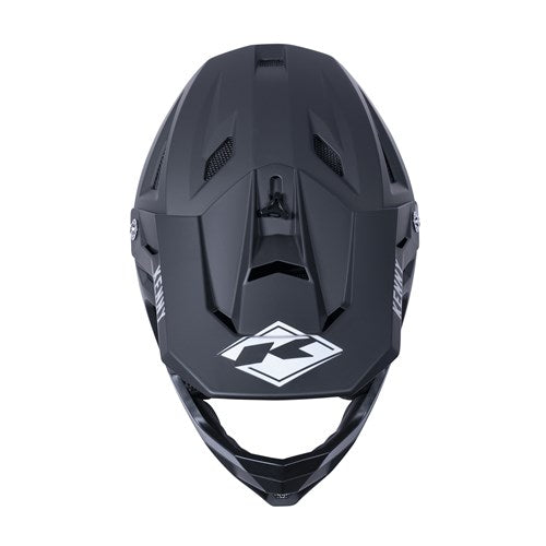 Matte black Kenny Racing Decade full-face helmet, angular design. Front view with air vents, top logo, and MIPS technology for enhanced safety.