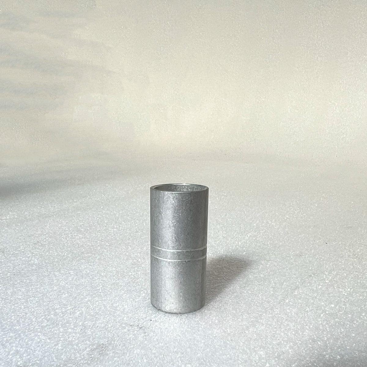 A 46mm Profile Tube Spacer stands vertically on a plain white surface, its cylindrical metal form reminiscent of the precision found in profile cranks.