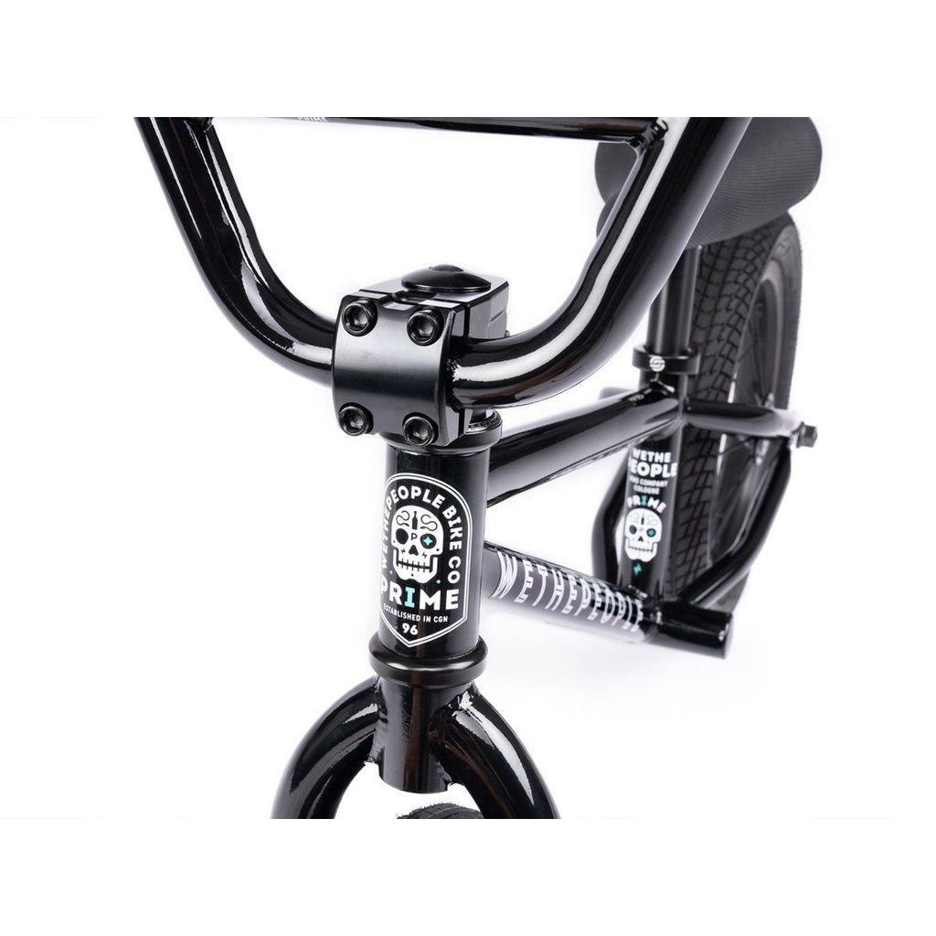 Close-up of the black handlebars and front fork of the Wethepeople Prime Balance BMX Bike, featuring sleek logos and branding.