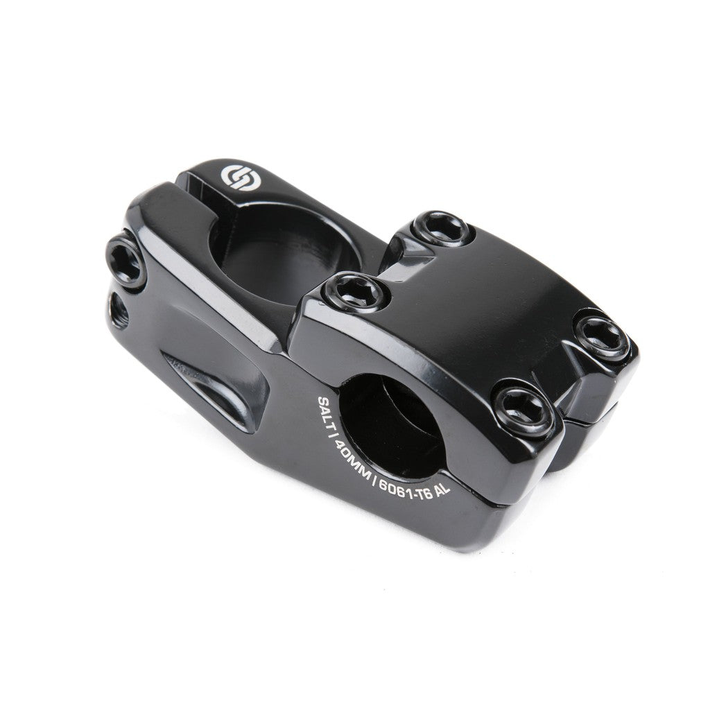 A black Salt Junior Top Load Stem 1 Inch, adorned with "SALT 140MM 6061-T6 AL" text, comes equipped with a four-bolt faceplate and clamp bolts on the side, providing an affordable option.