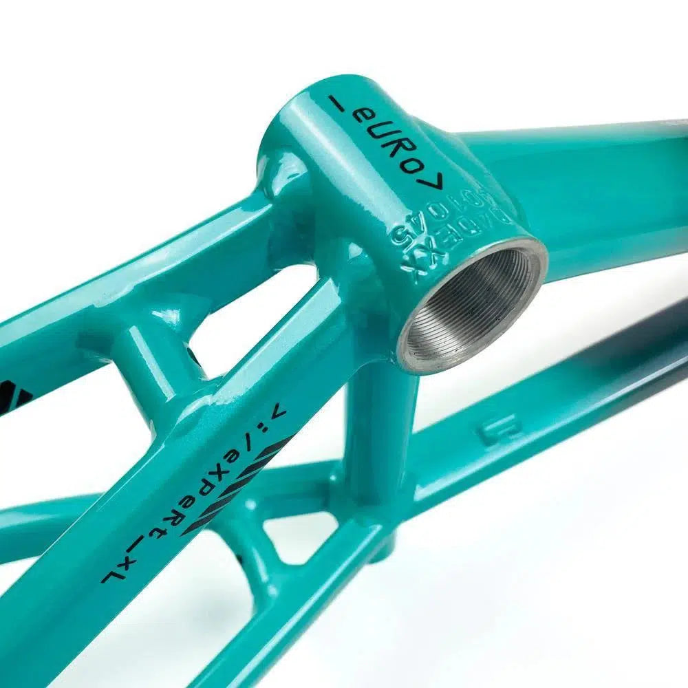 Close-up of a teal aluminium race frame showing the bottom bracket shell with the label "euro". The Staystrong V5 Disc Mini Frame features disc brake mounts and additional text and structural design details visible.