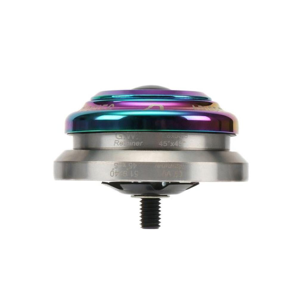 Close-up of a CNC machined Arise Crystal Integrated Headset, featuring a rainbow-colored top half and silver bottom half, with a visible axle and high-precision bearings.