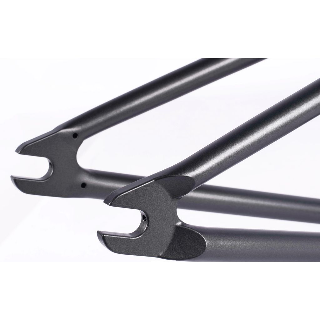 Close-up image of the dropouts on a black Cult Hawk Frame (Chase Hawk Signature). The metal components are shaped to secure the wheel axles, showcasing the precision and durability of this signature frame design.