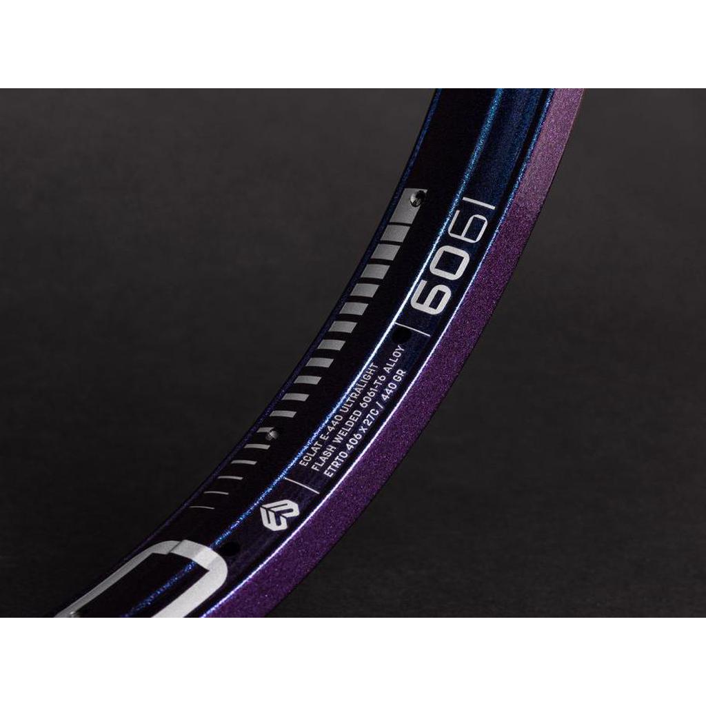 Close-up of the lightweight Eclat E440 Rim (36H) in purple and dark blue, displaying technical specs and "6061" against a dark background, ideal for a BMX wheelset.