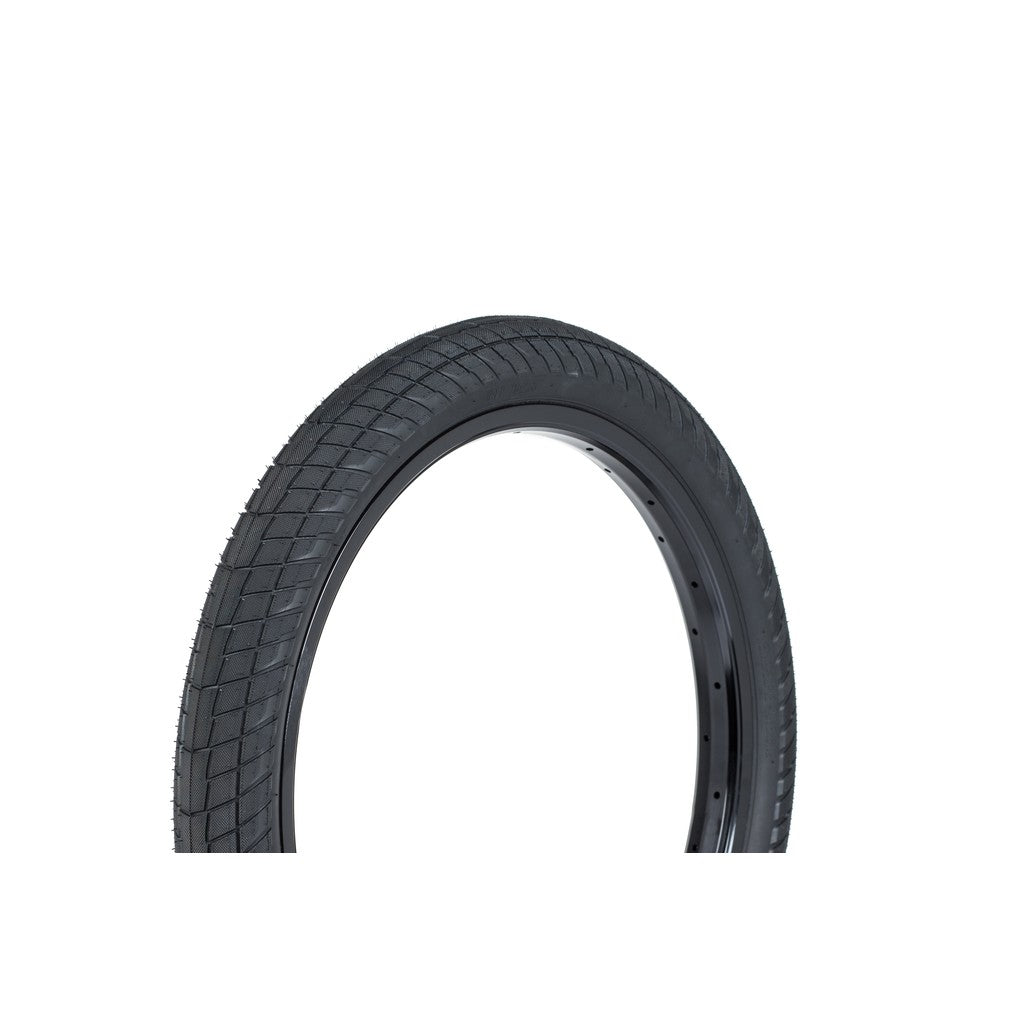 An isolated image of the Wethepeople Overbite Tyre (Each) / 20x2.35 / Black featuring a black rubber micro knurled tread pattern, set against a plain white background.