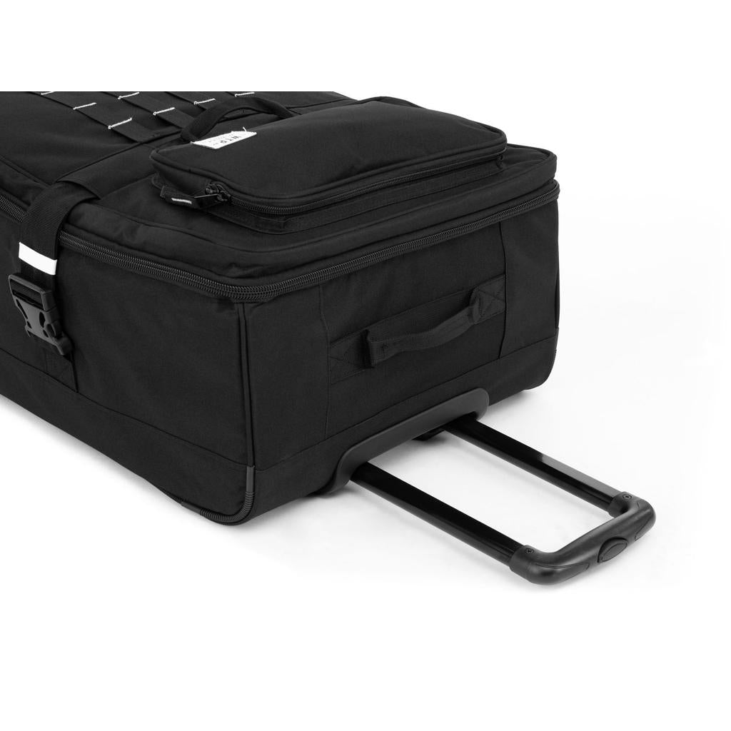 The Wethepeople Travel Bike Bag is a black rolling suitcase with an extended telescopic handle, zippered compartments, and a side handle, making it ideal airline-friendly luggage for seamless travel.