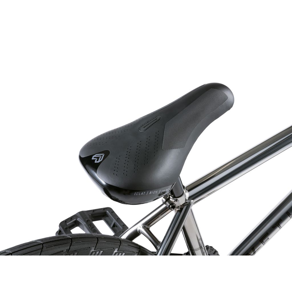 Close-up of a black bicycle seat on the shiny chromoly frame of the Wethepeople Envy 20 Inch BMX Bike, showing part of the rear wheel and pedal, ideal for any BMX enthusiast.