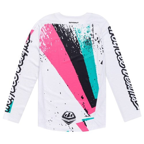 The TLD 25.1 Sprint Jersey / Full Pull Chalk features a white long-sleeve design with abstract pink, teal, and black patterns, and bold black text down the sleeves, capturing the race weekend energy and creativity of Troy Lee Designs.