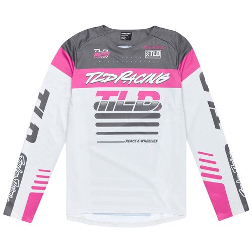 The TLD 25.1 Sprint Jersey / Fifty-50 Chalk is ideal for race weekends, featuring long sleeves with gray and pink accents, "TLD Racing" text, logos, and "Peace & Wheelies" on the front.