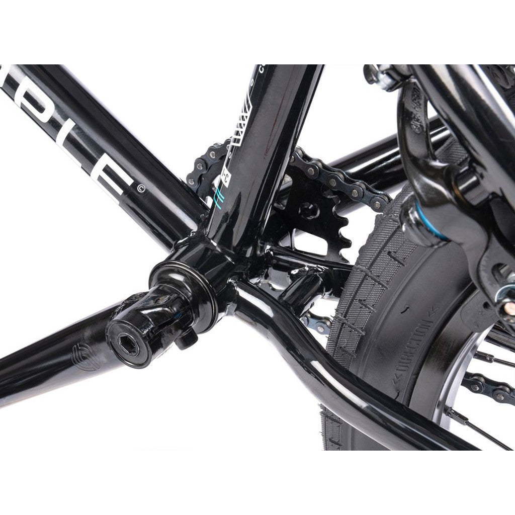 Close-up of the Wethepeople CRS FS 18 Inch BMX Bike frame showcasing the crank arm, chainring, and rear wheel, highlighting the mechanics and components.