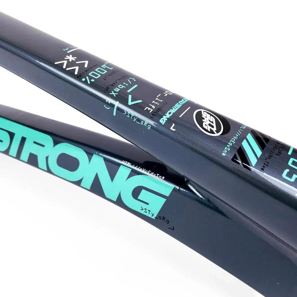 Close-up of a black aluminium race frame with turquoise "STRONG" lettering and various technical specifications printed on it. This Staystrong V5 Disc Pro XXXL Frame showcases the elegance of disc brake beauties.