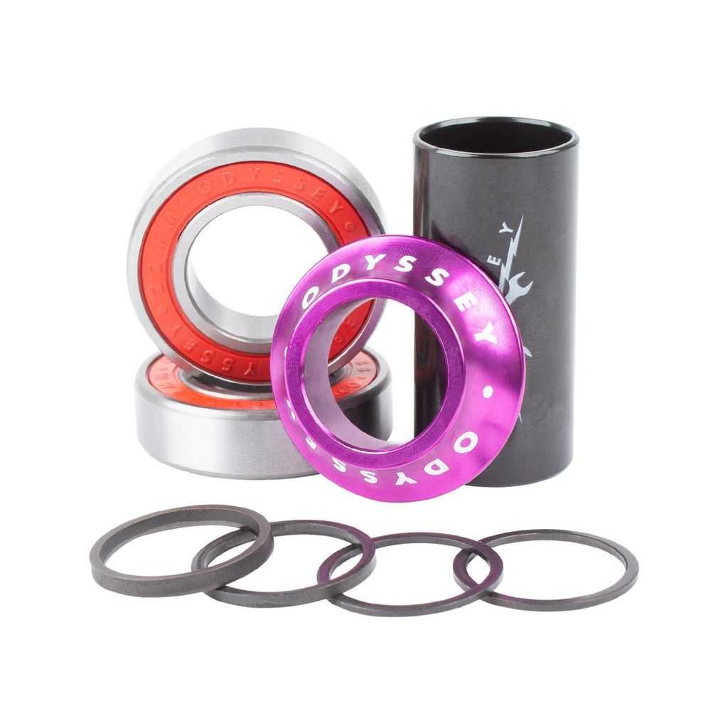 Assorted bicycle bearing components, including two ball bearings, one purple spacer, one black cylinder, and five smaller washers arranged on a white background—perfect for press-fit Mid BB frames or upgrading your Odyssey Mid Bottom Bracket and crank spindles.