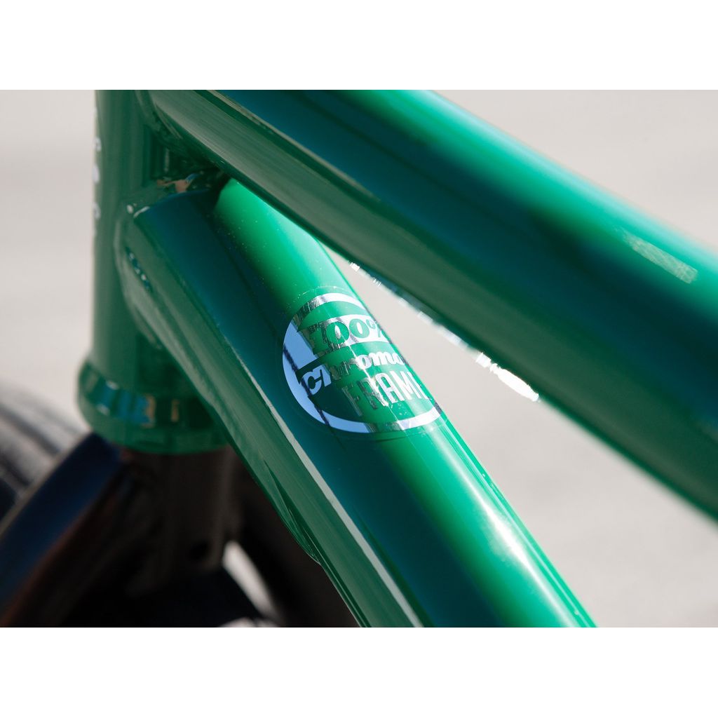 Close-up view of a green Sunday Forecaster 20 Inch Bike (2022) / Alec Siemon, showcasing the frame with white text declaring "100% Chromoly Frame," accompanied by an Odyssey Clutch v2 Freecoaster to deliver smooth, cutting-edge performance.