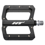 A black bicycle pedal, labeled "HT," boasts an open design with multiple screws along the edges and a metallic spindle for attachment. The HT - NANO AN01 Flat Pedals are crafted from CNC machined aluminium and feature durable chromoly spindles.