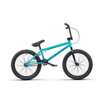 The Wethepeople Nova 20 Inch Bike is a sleek BMX featuring Salt Rookie Cranks, with a vibrant blue frame, black tires, and handlebars, stylishly viewed from the side.