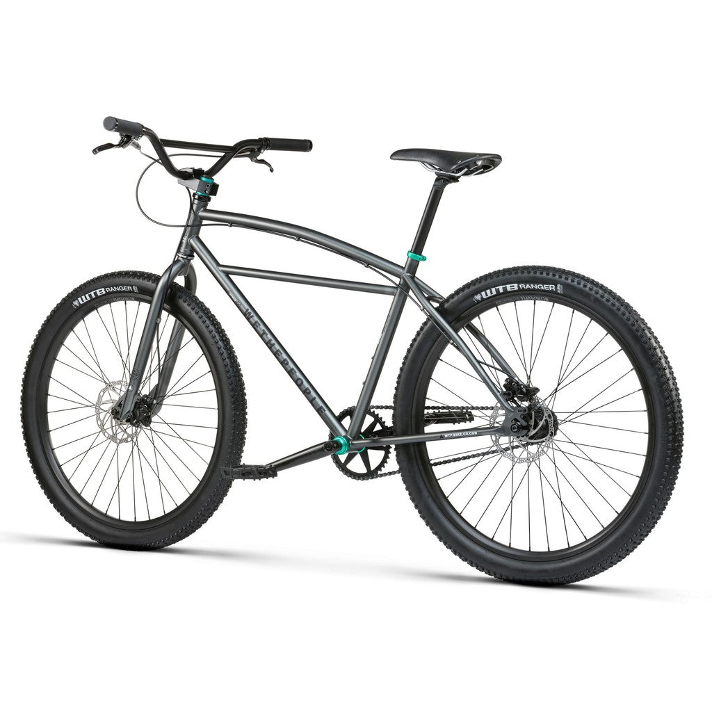 The Wethepeople Avenger 27.5 Inch Bike, with wide tires and a straight handlebar, features reliable disc brakes for smooth rides across various terrains.