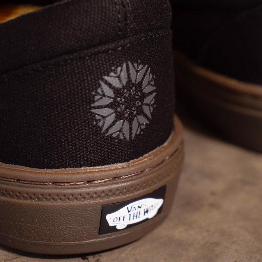 Black vans slip ons hotsell gum sole