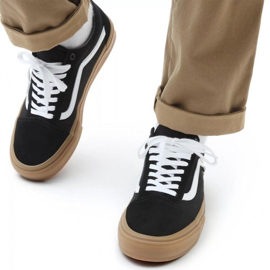 All black old shop skool vans gum sole