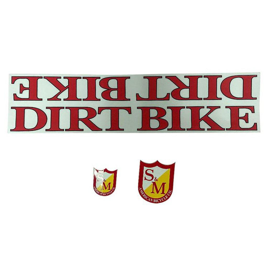 The S&M Dirt Bike Frame Decal Set includes two decals: one with "DIRT BIKE" in red, inversely and normally, plus a frame decal set featuring two smaller shield-shaped "S&M American Bicycle Co" stickers in bold red and yellow, ideal for updating your bike's look.