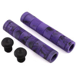 Two Alienation Backlash V2 flangeless bicycle grips in purple with black plugs, boasting a ribbed texture and black speckles. Made from proprietary rubber, these grips ensure increased comfort and durability.