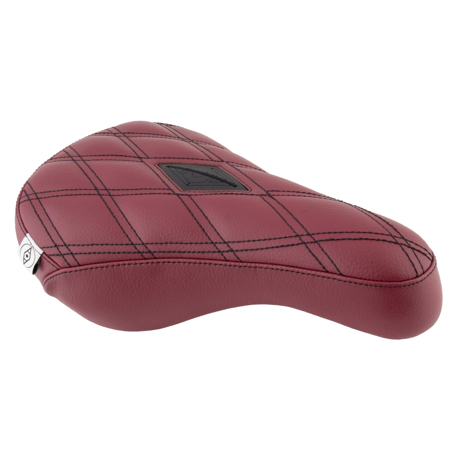 The Alienation Gripper Pivotal Seat is a red bicycle seat with a black grid pattern and oval logo patch, made from Gripper material for better stability.