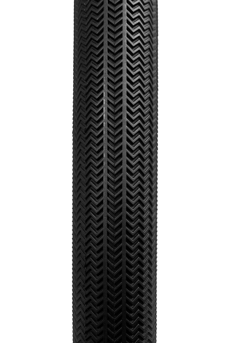 Close-up of the Alienation TCS R1 Tyre, a black racing tire with a herringbone tread pattern, displayed vertically against a white background. This tubeless and foldable design enhances performance and reliability.