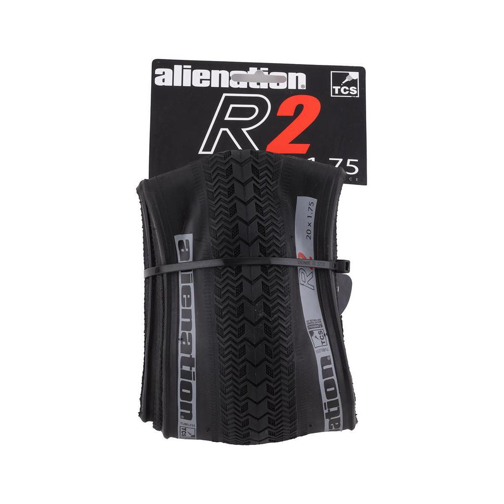 The Alienation TCS R2 Tyre (Tubeless/Foldable) measures 20 x 1.75 and is strapped to its packaging. Its directional pattern ensures optimal performance, making it ideal for cyclists seeking precision and reliability.