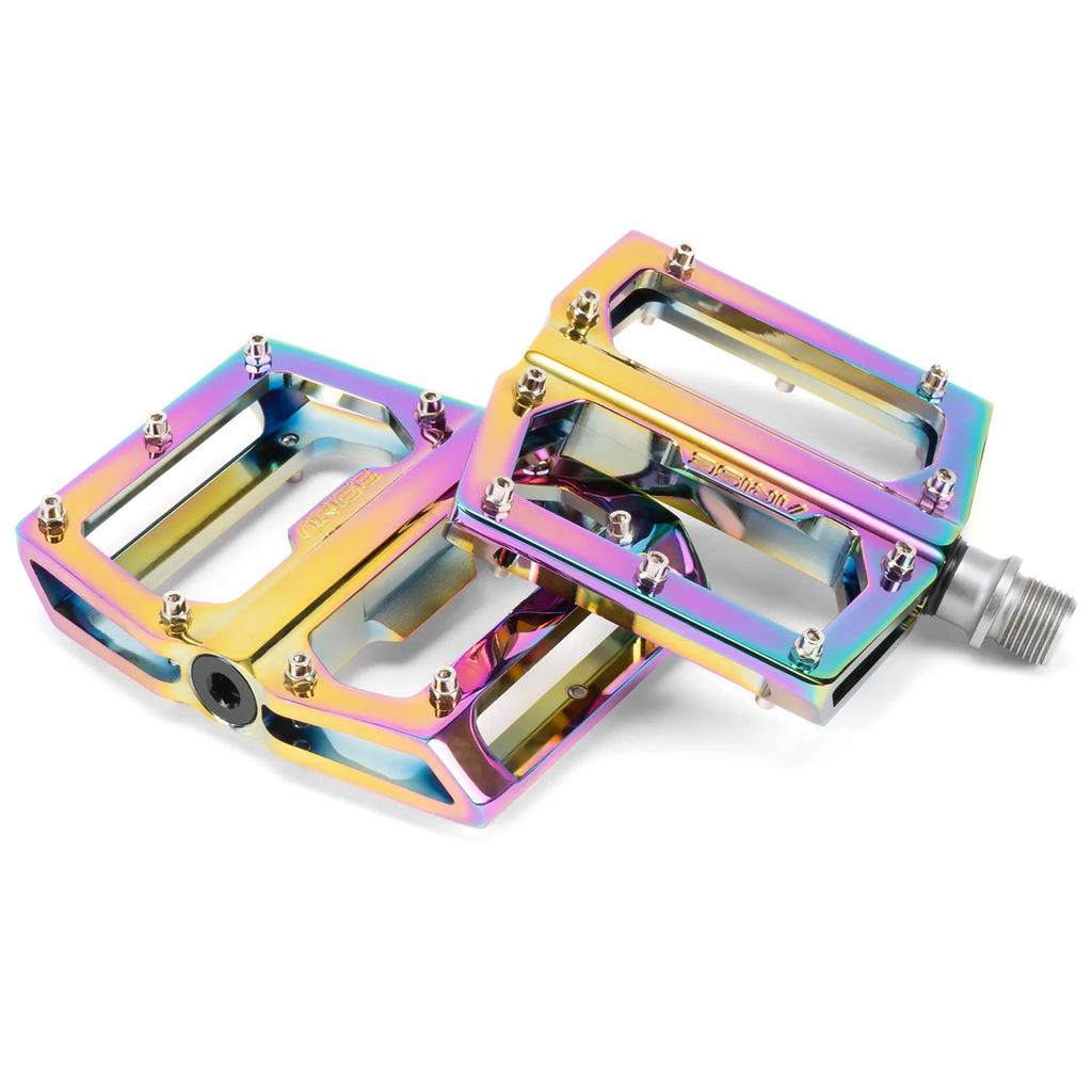 The Arise Xenon Expert Pedals are metallic bike pedals with a colorful, iridescent finish, featuring a sealed bearing system for smooth performance and durability.